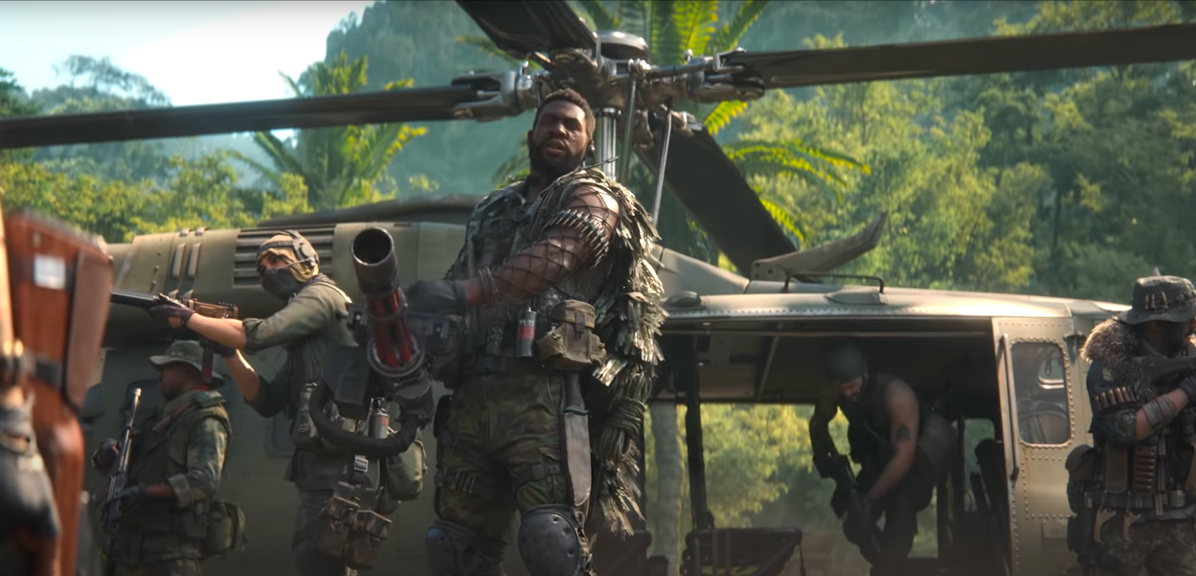 A new Call of Duty: Black Ops Cold War Operator stands in front of a helicopter with a minigun
